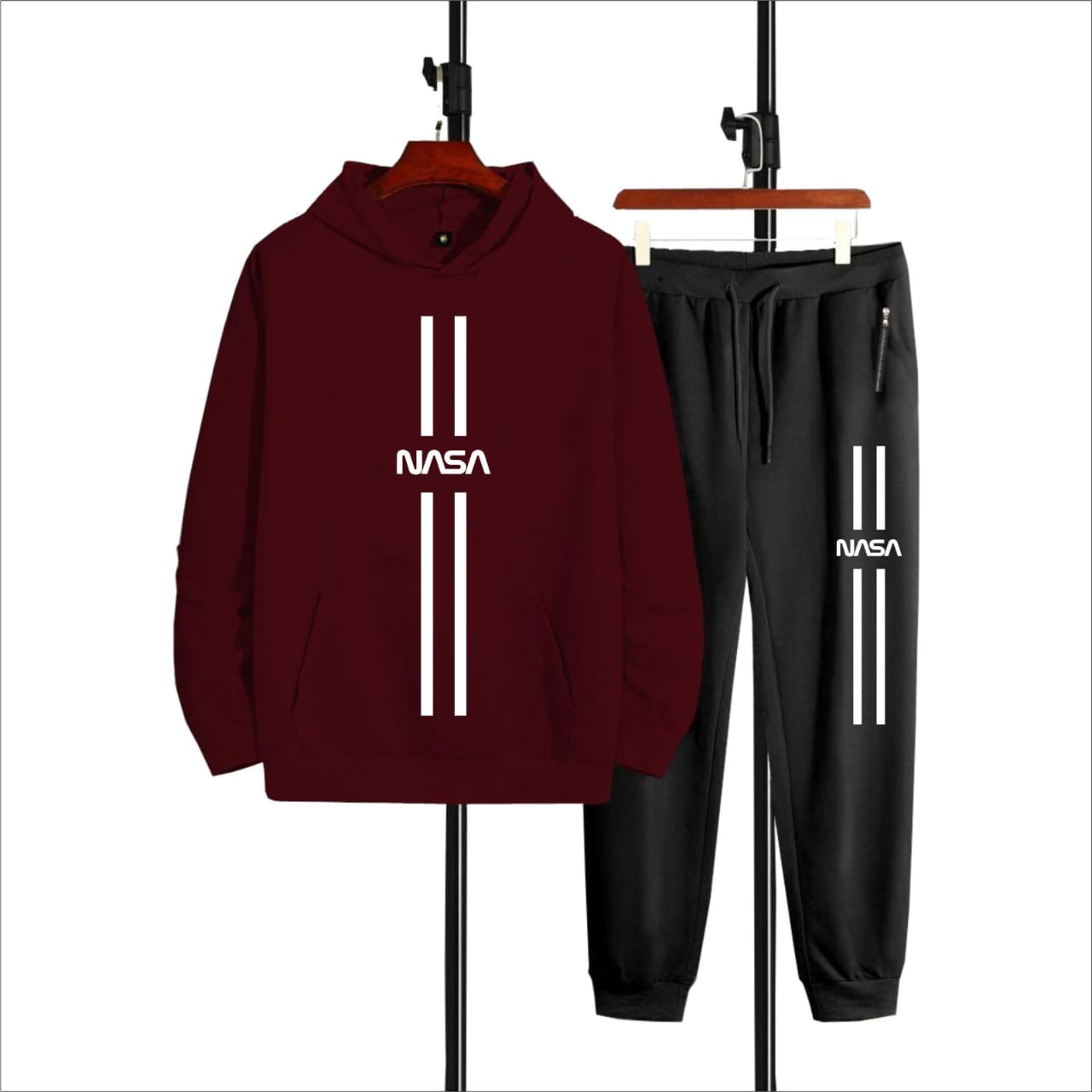 Maroon hoodie and black pants set with NASA logo on hangers against a white background